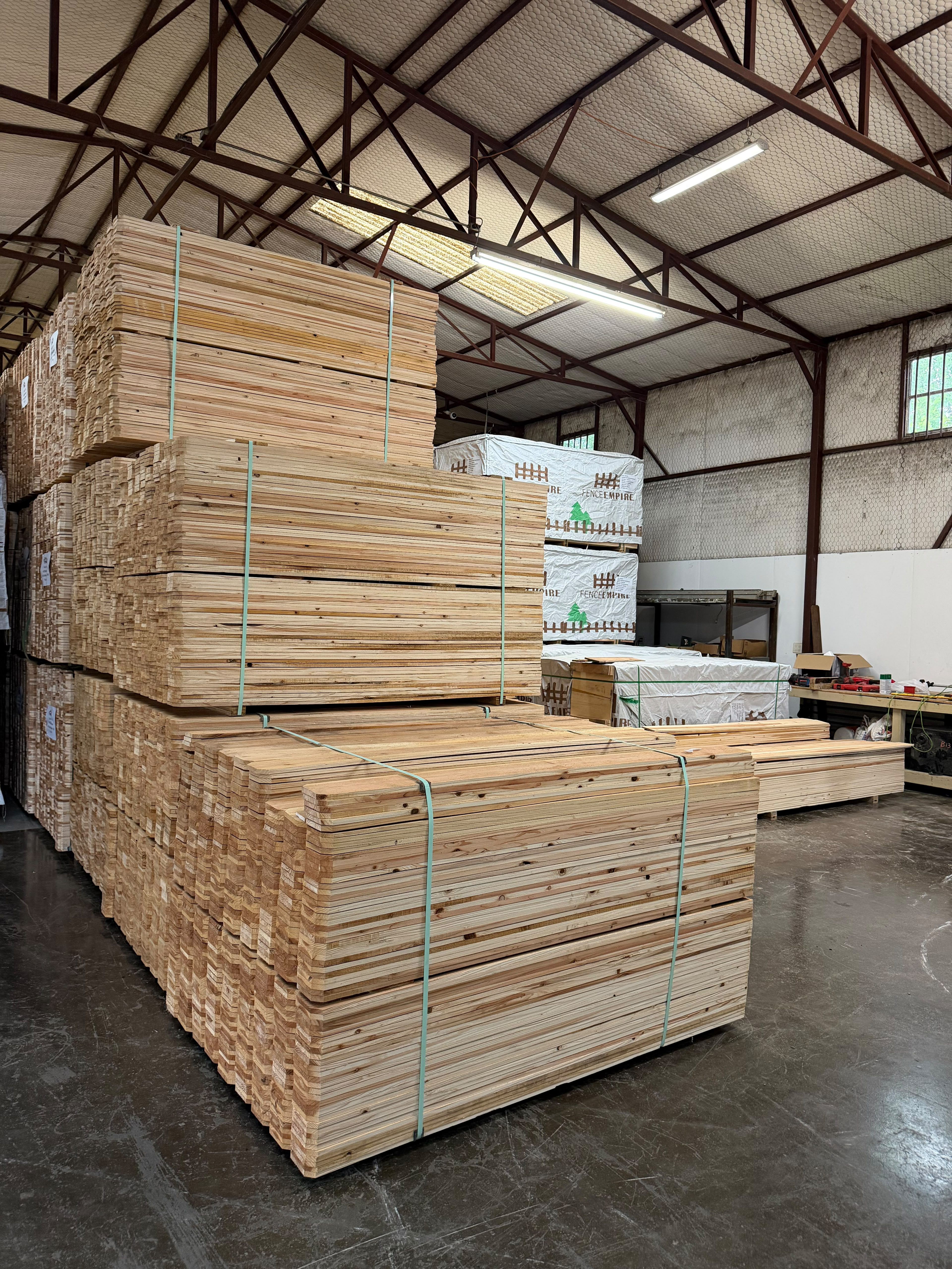Stacked cedar picket bundles in warehouse